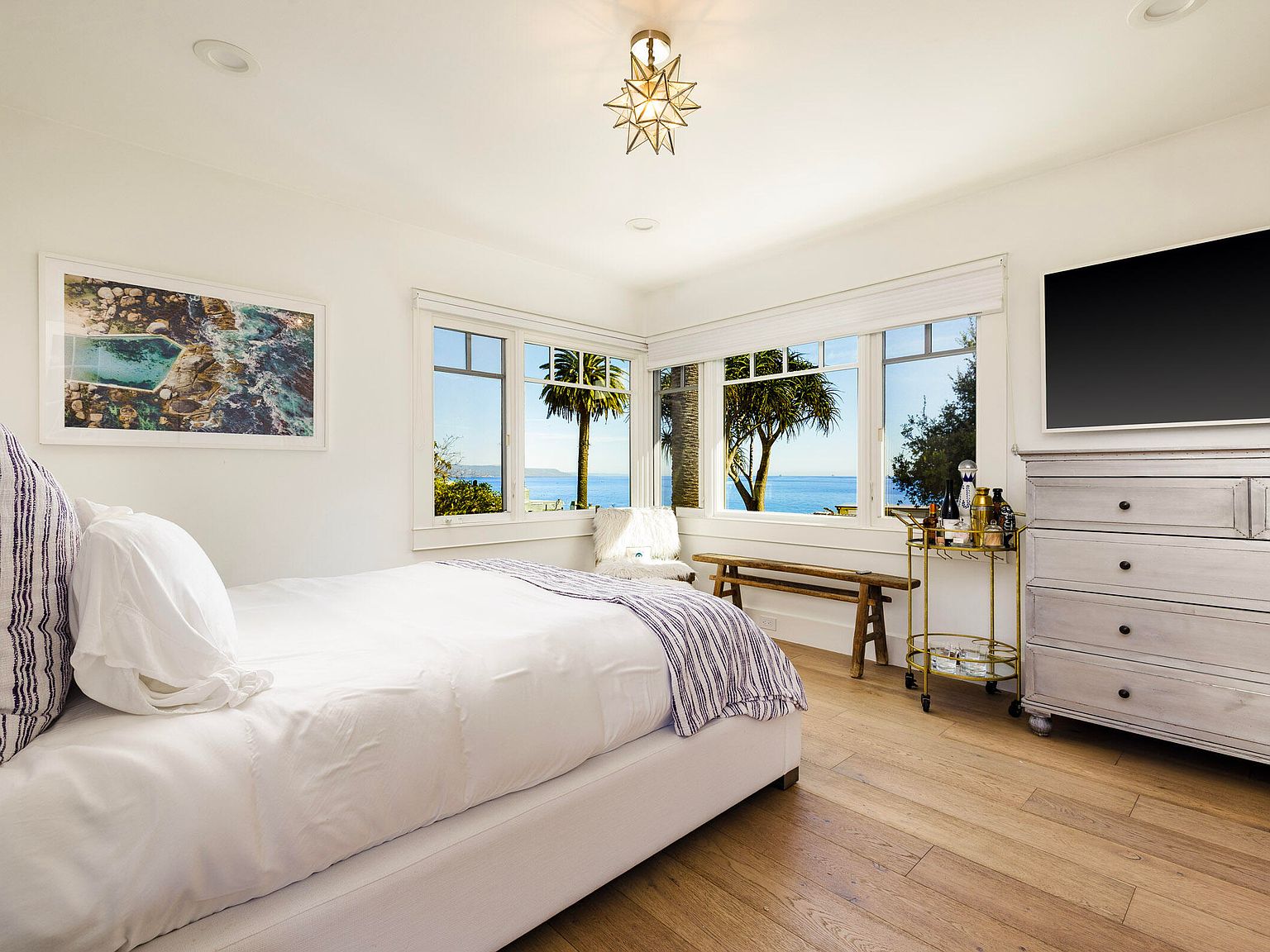 Palms and coastal sky framing the property's line to the horizon.